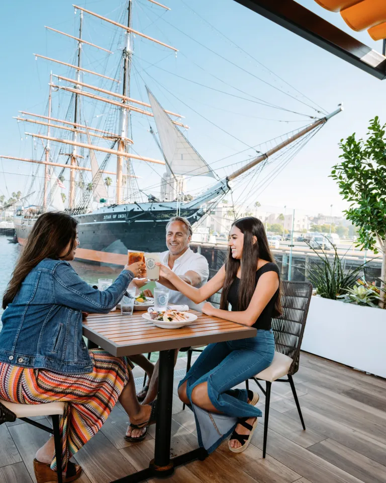 Family clinking glass with a great meal at Portside Pier on San Diego Bay
