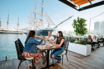 Family clinking glass with a great meal at Portside Pier on San Diego Bay 
